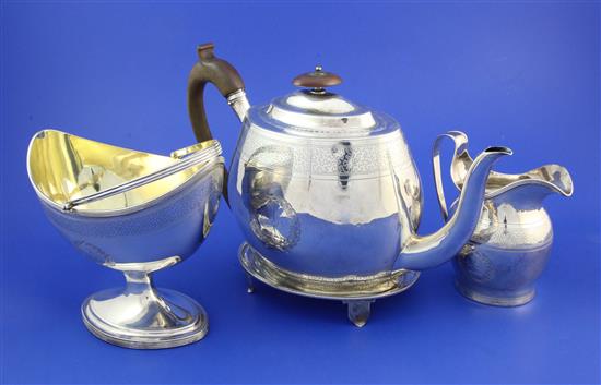 A George III silver teapot on stand, Adam style sugar basket and cream jug by Alexander Field, gross 30.5 oz.